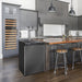 Black stainless Kegco K309 Kegerator installed beside a wood island counter in a grey modern kitchen