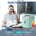 Quiet 40 decibel operation of the Kismile Z5815NH Countertop Ice Maker beside a man on the phone